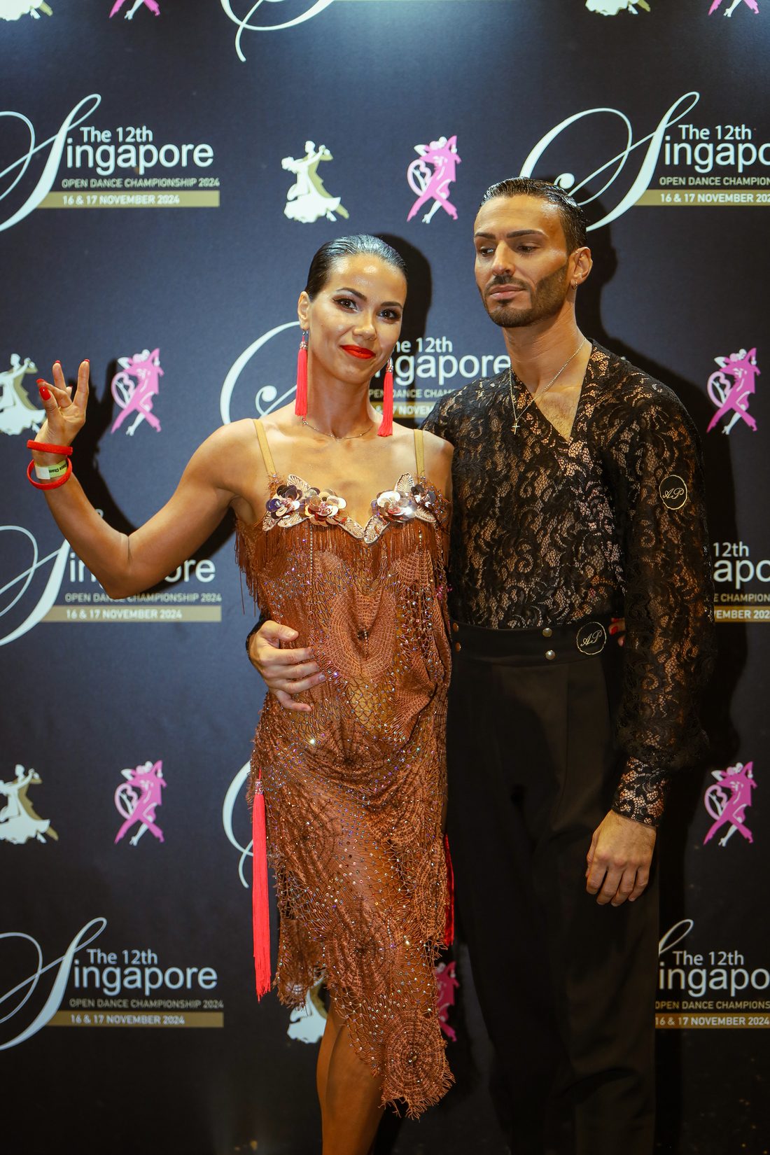Raliza Velichkova in a bronze fringed Latin dress with her dance partner at the Singapore Open Dance Championship