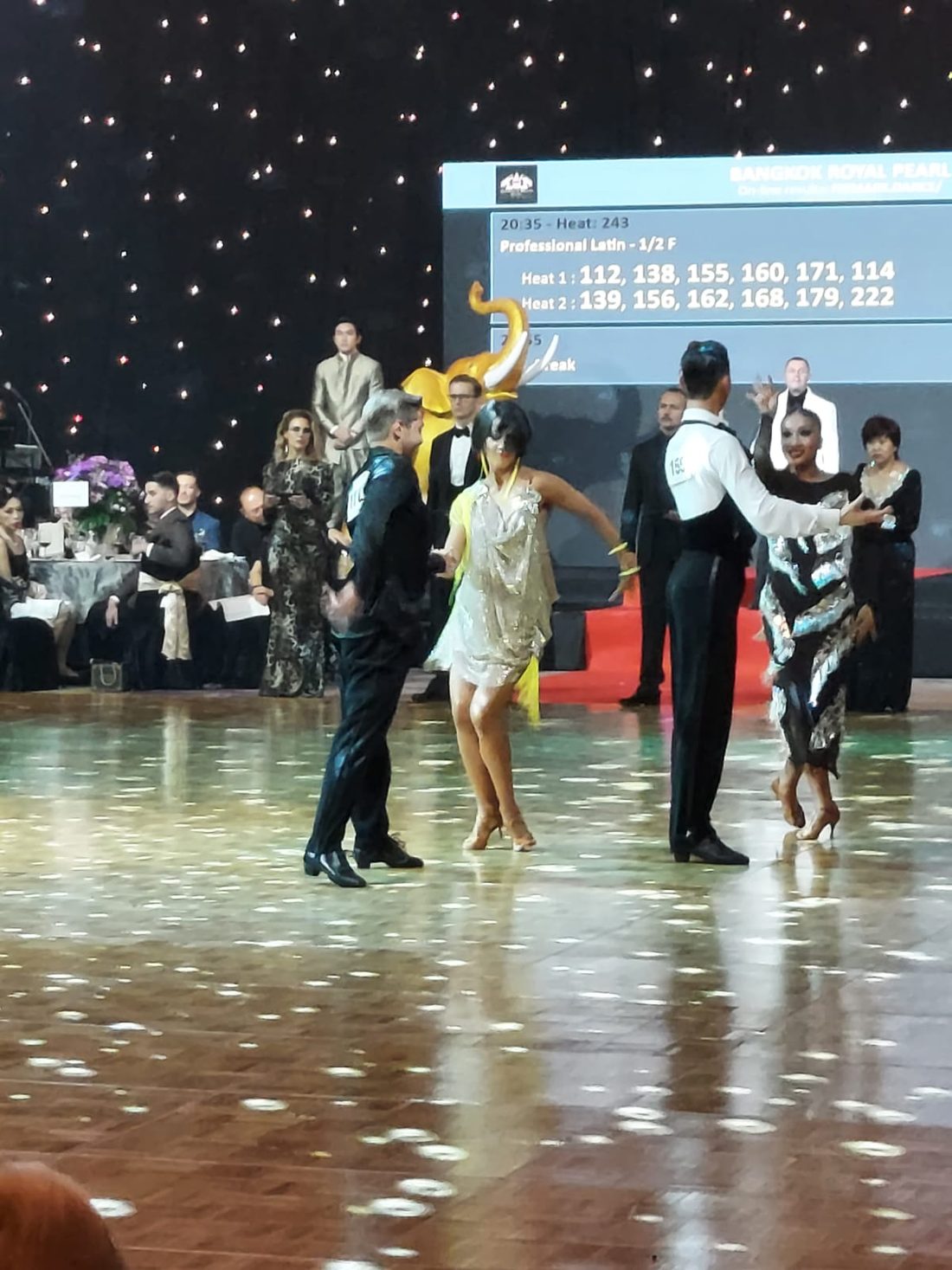 Raliza performing a Great Gatsby-themed show in a beaded dress at a gala dinner